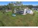 Aerial view showcasing the house's backyard and surrounding landscape at 92 Wood Hall Dr, Mulberry, FL 33860