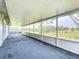 Large screened porch with a view of the tranquil backyard landscape at 92 Wood Hall Dr, Mulberry, FL 33860