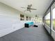 Relaxing screened porch with ceiling fans and outdoor seating at 92 Wood Hall Dr, Mulberry, FL 33860
