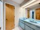 Bathroom with double vanity, light blue countertop, and a shower at 92 Wood Hall Dr, Mulberry, FL 33860