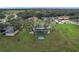 Aerial view showing home's backyard, pool, and surrounding landscape at 92 Wood Hall Dr, Mulberry, FL 33860