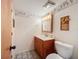 Clean bathroom with wood vanity, single sink, and toilet at 92 Wood Hall Dr, Mulberry, FL 33860