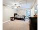 Bright bedroom with ceiling fan and access to laundry at 92 Wood Hall Dr, Mulberry, FL 33860