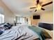 Main bedroom with a king-size bed, dresser, and access to the balcony at 92 Wood Hall Dr, Mulberry, FL 33860