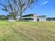 Spacious backyard with a large lawn and above ground pool at 92 Wood Hall Dr, Mulberry, FL 33860