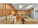 Open kitchen with wood cabinets, granite countertops, and stainless steel appliances at 4264 Stafford Dr, Winter Haven, FL 33880