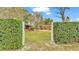 Neat front yard with manicured hedges and private gate at 4264 Stafford Dr, Winter Haven, FL 33880