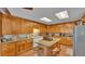 Kitchen boasts ample wood cabinets, granite countertops, and an island with a cooktop at 4264 Stafford Dr, Winter Haven, FL 33880