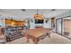 Spacious game room with a pool table, leather furniture, and a large TV at 4264 Stafford Dr, Winter Haven, FL 33880