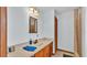 Simple bathroom with wooden vanity and a light blue wall at 4264 Stafford Dr, Winter Haven, FL 33880