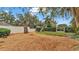Landscaped backyard with wood chips, privacy fence, and mature trees at 4264 Stafford Dr, Winter Haven, FL 33880
