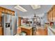 Kitchen offers an island with cooktop, stainless steel appliances, and views to dining area at 4264 Stafford Dr, Winter Haven, FL 33880