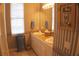 Bathroom with double sinks, striped wallpaper, and shower at 108 Lake Region N Blvd, Winter Haven, FL 33881