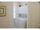 Convenient laundry room with washer, dryer, and cabinets at 108 Lake Region N Blvd, Winter Haven, FL 33881