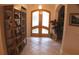 Bright entryway with tiled flooring and wooden shelving unit at 108 Lake Region N Blvd, Winter Haven, FL 33881