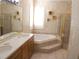 Bathroom with double vanity, corner bathtub, and shower at 108 Lake Region N Blvd, Winter Haven, FL 33881