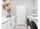 Laundry room with white cabinets, washer, dryer, and built-in shelving at 1324 Melrose St, Lake Alfred, FL 33850