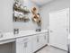 Bright laundry room with white cabinets, a countertop, and stylish wall decor at 1324 Melrose St, Lake Alfred, FL 33850