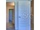 Bright hallway with white doors and wood floors at 1564 Leamington Ln, Winter Haven, FL 33884