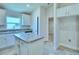 Island kitchen with granite countertops and white cabinets at 1564 Leamington Ln, Winter Haven, FL 33884