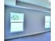Light-filled living room featuring multiple windows and neutral walls at 1564 Leamington Ln, Winter Haven, FL 33884