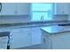 Kitchen with light cabinets, granite countertops and stainless steel appliances at 1564 Leamington Ln, Winter Haven, FL 33884