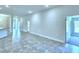Open living room with tile flooring and access to kitchen and hallway at 1564 Leamington Ln, Winter Haven, FL 33884