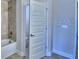 Bathroom with tub and door to another room at 1564 Leamington Ln, Winter Haven, FL 33884