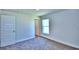 Well-lit bedroom with carpet flooring and an adjacent bathroom at 1564 Leamington Ln, Winter Haven, FL 33884