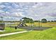 playground with swings and slide near lake at 1564 Leamington Ln, Winter Haven, FL 33884