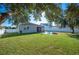 Spacious backyard with green grass and fire pit area at 1849 Charleston Ln, Bartow, FL 33830