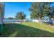 Spacious backyard with grassy lawn, privacy fence, and patio area at 1849 Charleston Ln, Bartow, FL 33830