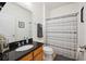 Clean bathroom with granite countertop and striped shower curtain at 1849 Charleston Ln, Bartow, FL 33830