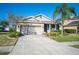 Single-story home with a two-car garage and landscaped yard at 1849 Charleston Ln, Bartow, FL 33830