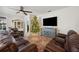Living room featuring leather sofas, a large TV, and a Christmas tree at 1849 Charleston Ln, Bartow, FL 33830