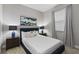 Bright bedroom with a full-size bed, nightstands, and window coverings at 7004 Oakwood St, Davenport, FL 33837