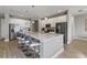 Modern kitchen with white cabinets, stainless steel appliances, and a large island with seating at 7004 Oakwood St, Davenport, FL 33837