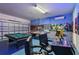 Game room boasts a pool table, air hockey, and arcade games at 7004 Oakwood St, Davenport, FL 33837