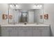 Double vanity bathroom with modern finishes and a large mirror at 7004 Oakwood St, Davenport, FL 33837