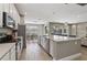 Modern kitchen boasting white cabinets, stainless steel appliances and an expansive island at 7004 Oakwood St, Davenport, FL 33837