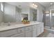 Clean bathroom with double vanity and a walk-in shower at 7004 Oakwood St, Davenport, FL 33837
