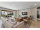 Spacious living room with a large TV, cozy seating area, and access to a backyard pool at 7004 Oakwood St, Davenport, FL 33837
