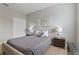 Bedroom with a queen-size bed, nightstands, and wall art at 7004 Oakwood St, Davenport, FL 33837
