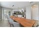 Elegant dining room with a long table and view of the living room at 7004 Oakwood St, Davenport, FL 33837