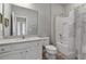 Clean bathroom with single sink vanity, toilet, and shower/tub combo at 7004 Oakwood St, Davenport, FL 33837