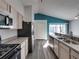 Modern kitchen with stainless steel appliances and an island at 742 Sonja Cir, Davenport, FL 33897