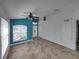 Bright living room with tile floors, high ceilings and teal accent wall at 742 Sonja Cir, Davenport, FL 33897