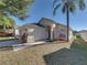 Tan single story home with white garage door and landscaping at 742 Sonja Cir, Davenport, FL 33897