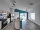 Bright kitchen with stainless steel appliances and vinyl plank flooring at 742 Sonja Cir, Davenport, FL 33897