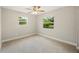 Bright bedroom with ceiling fan and plush carpeting at 9004 Pine Tree Dr, Lakeland, FL 33809